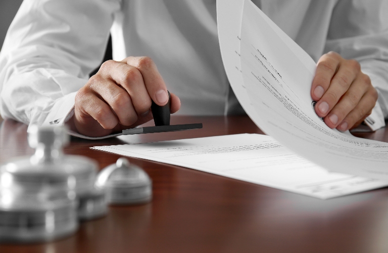 notary is putting a stamp on the document