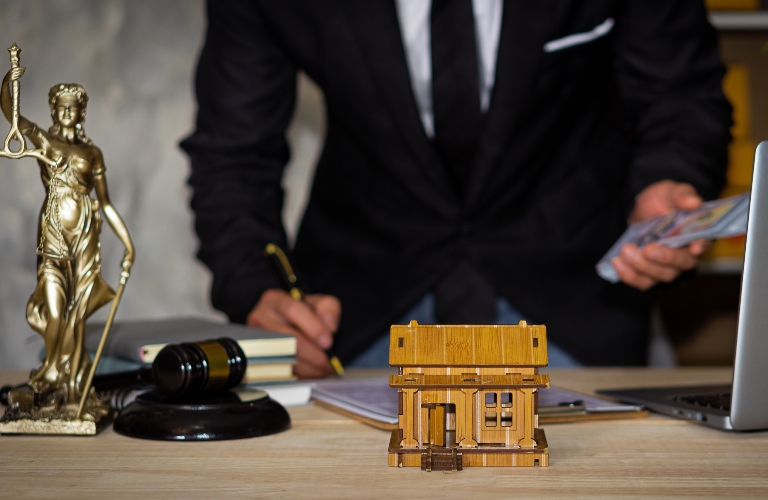 Close-up of house laying in front of businessman